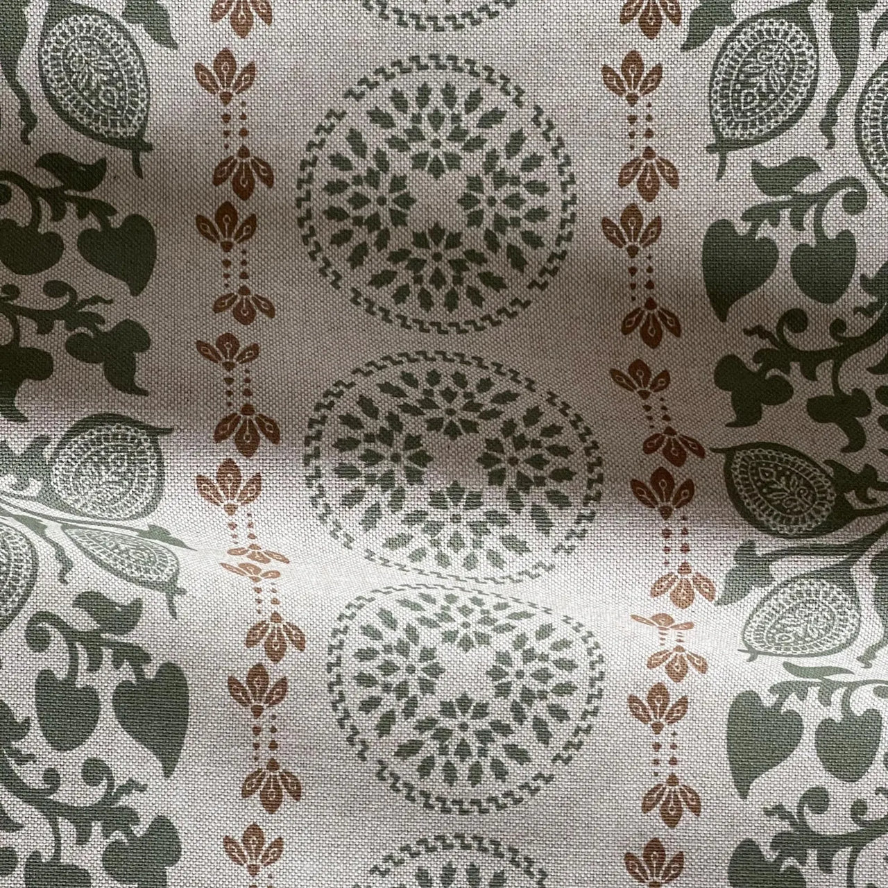 Sage green upholstery fabric with vertical botanical bands and decorative accents