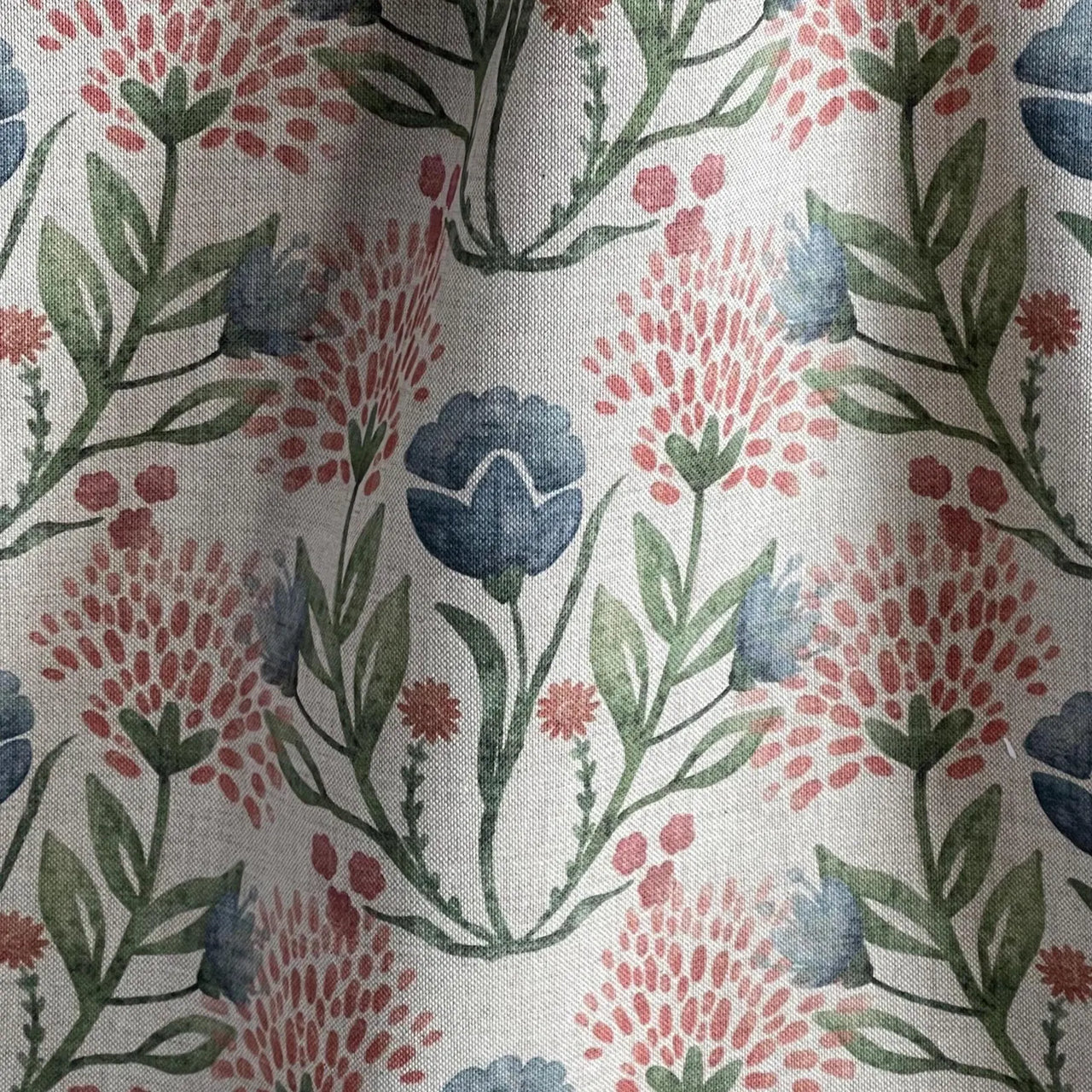 Indigo and blush floral fabric with leafy green stems on beige background