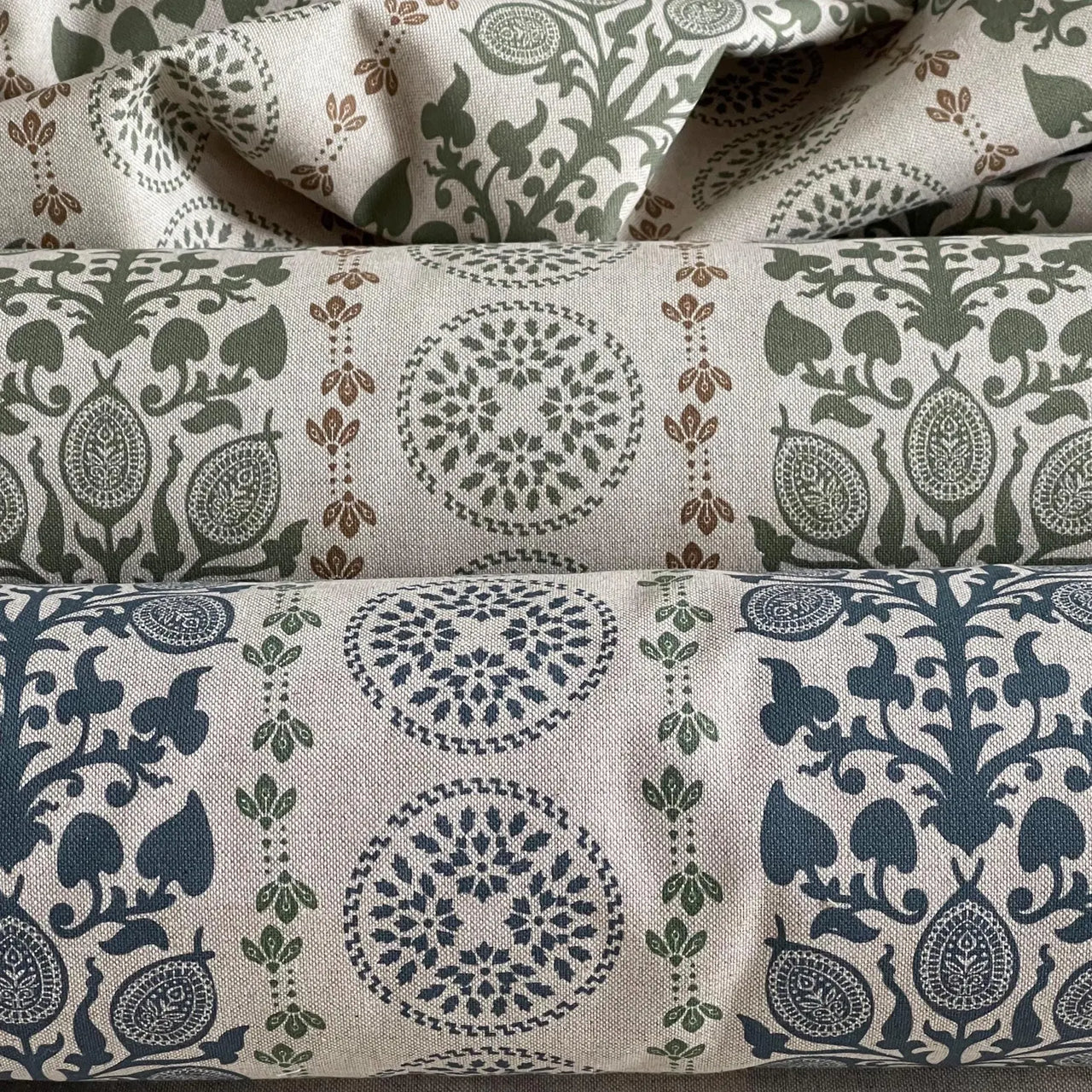 Rustic country style fabric with sage green botanical motifs and linen texture