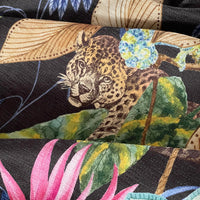 Thumbnail for Close-up of fabric with a leopard and floral design on a black background