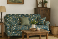 Thumbnail for Cottage-style living room with a teal blue tapestry sofa upholstered in peacock and floral print fabric, featuring rustic wood furniture and vintage decor.