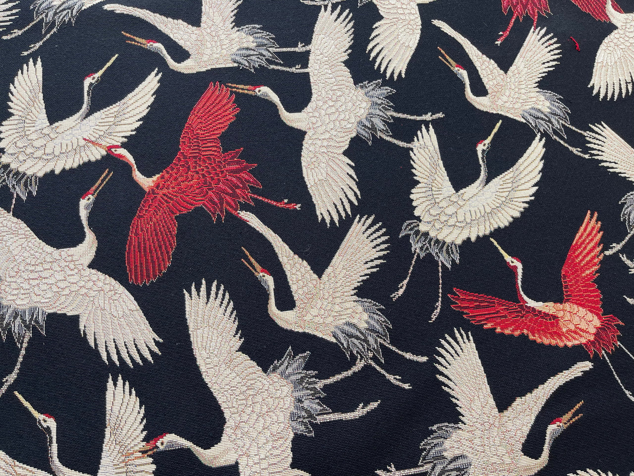 Woven decorative textile with flying cranes