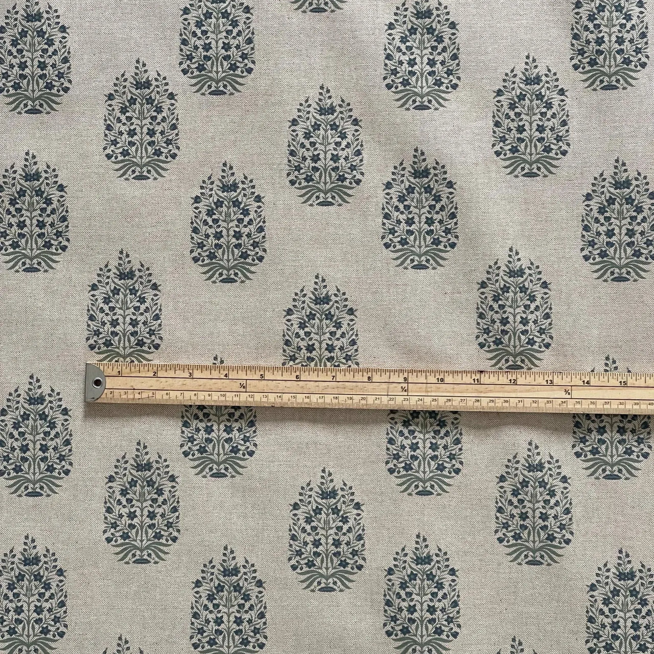 Folk floral fabric with repeating medallion layout in soft blue tones