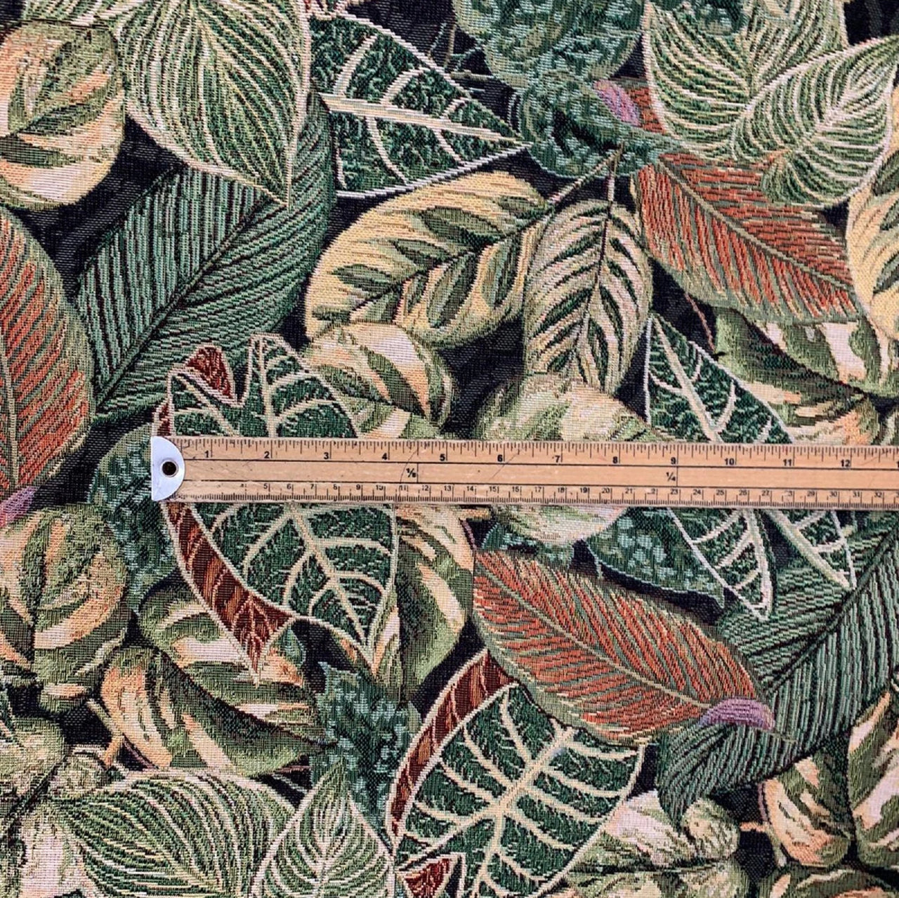 Nature-inspired green and mustard leaves fabric.

