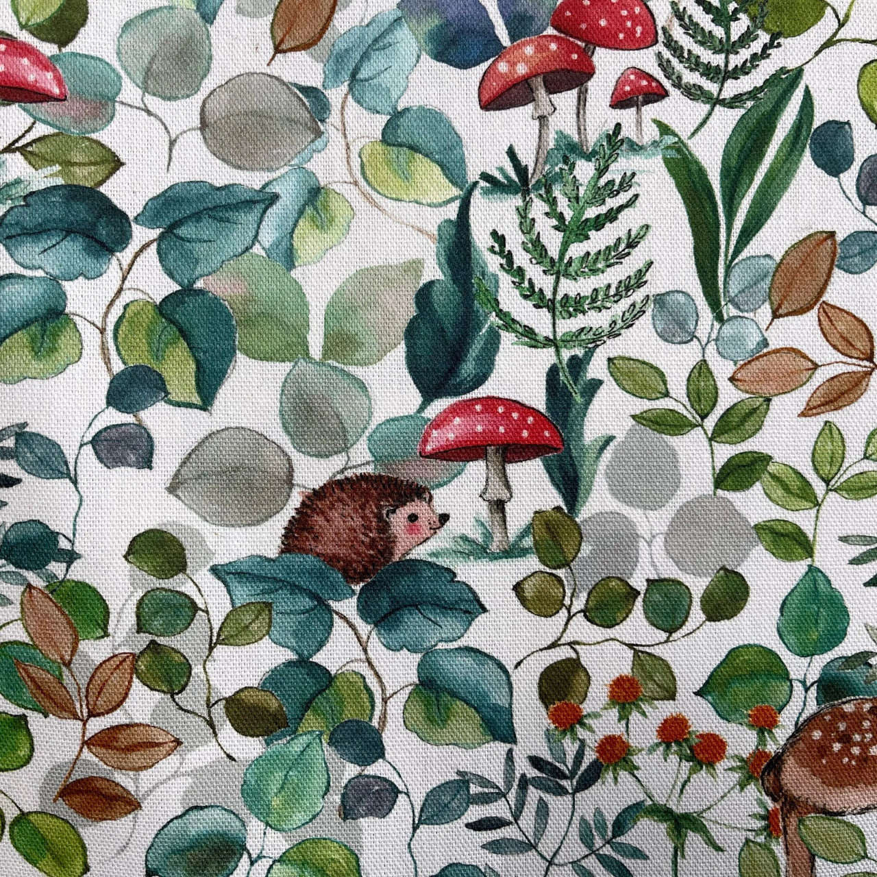 Nature-inspired fabric showing deer, hedgehogs, mushrooms, and leaves – perfect for kids’ rooms, cushions, and curtains.