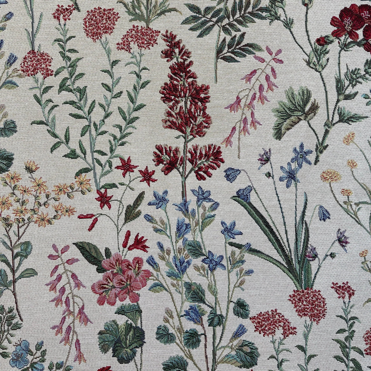 Detailed view of floral jacquard fabric showing intricate woven flowers and foliage in rich colors on a cream background.