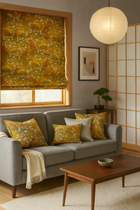 Thumbnail for A modern contemporary living room with Japanese influence featuring a Roman blind made from fabric with an almond blossom pattern on a warm amber-gold background. The blind covers a wooden-framed window above a gray sofa adorned with matching patterned pillows. The room also includes a wooden coffee table, a neutral rug, a minimalist abstract wall art piece, a paper lantern pendant light, a shoji screen, and a small bonsai tree on a side table, creating a serene and elegant atmosphere.