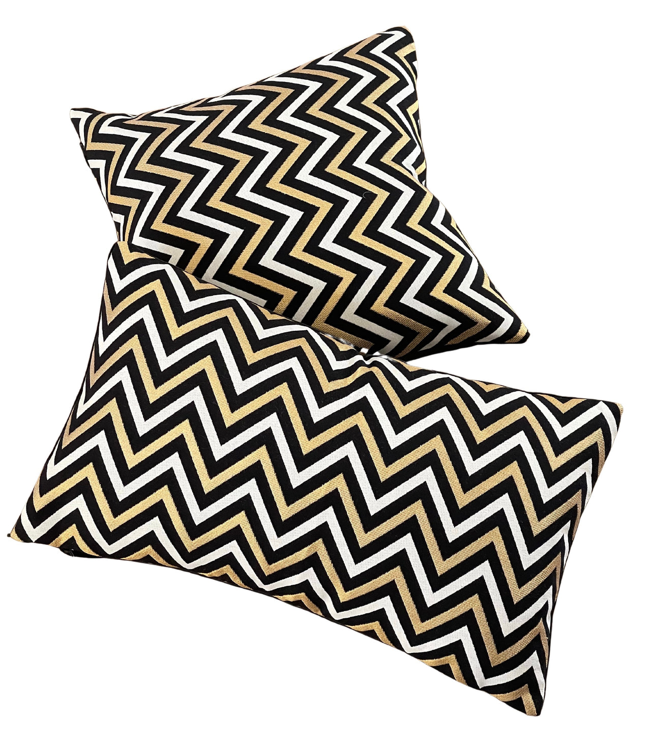 Bold chevron design cushion in black, white, and gold.