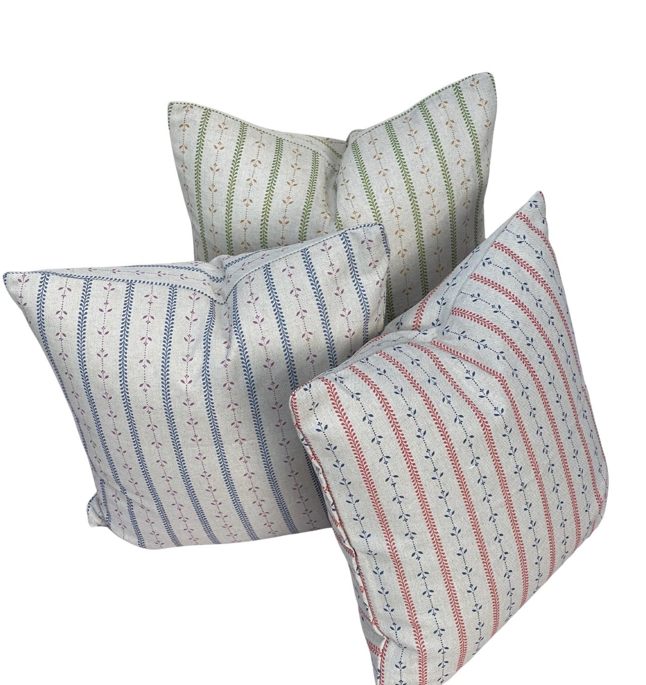 Blue, red and green botanical stripe cushion covers on a white background