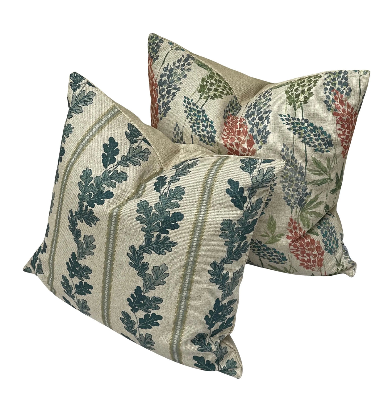 Close-up of clover and fern sprigs in sap green, red and indigo on linen-look oatmeal fabric.