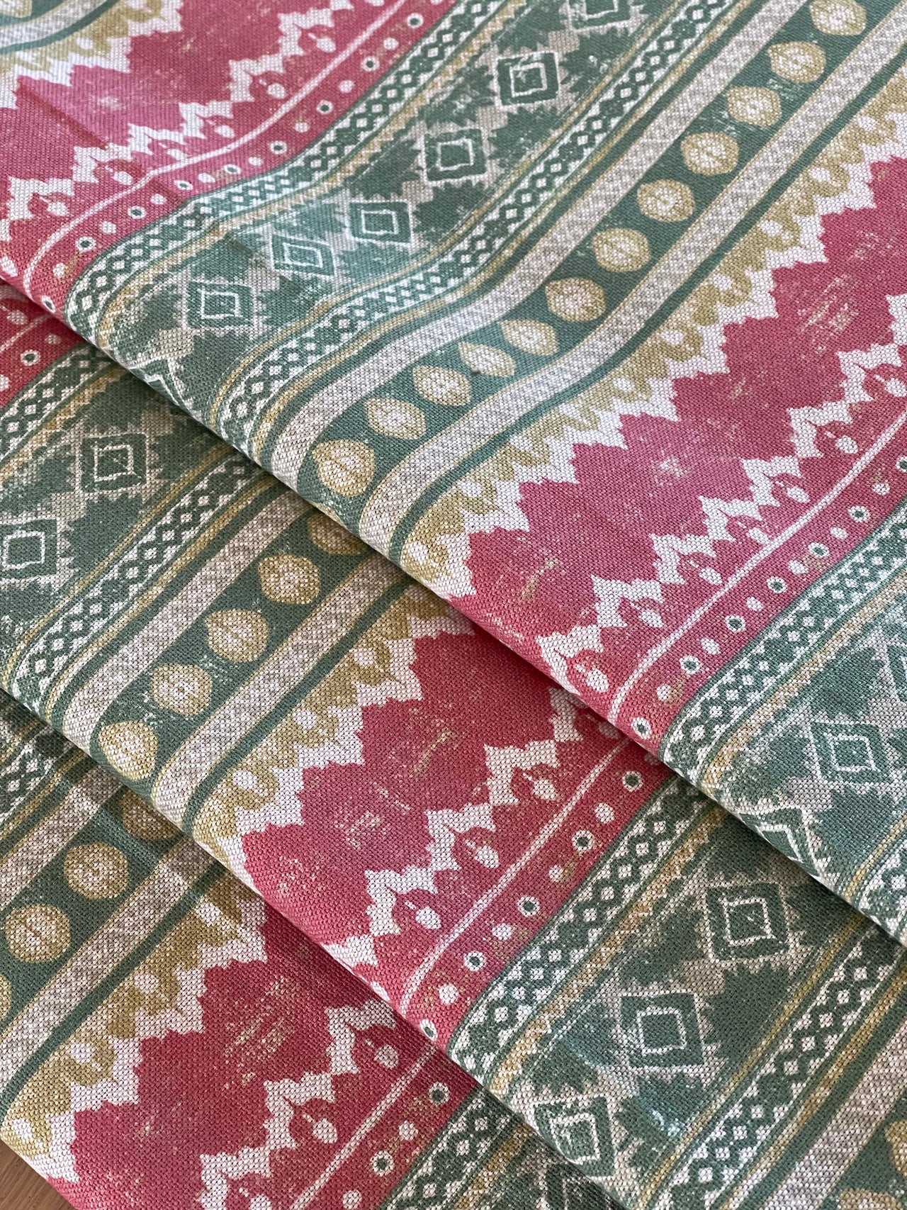 Patterned fabric swatches in red, green, and beige.