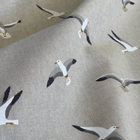 Thumbnail for Fabric with a pattern of seagulls on a textured beige background