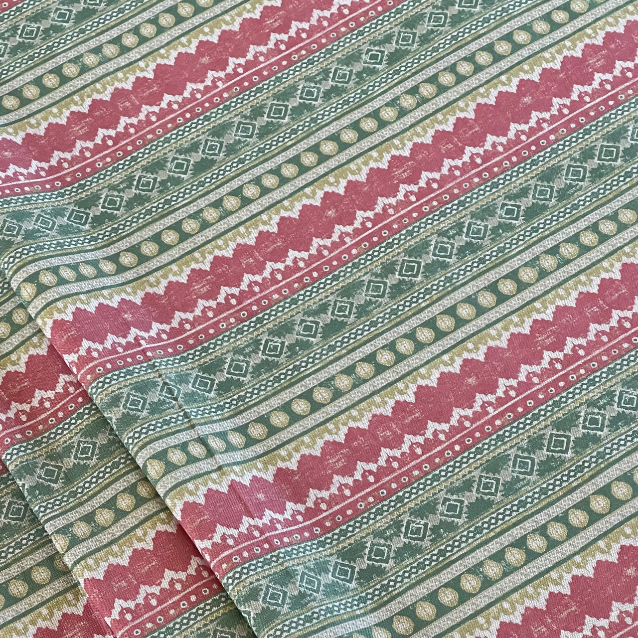Patterned fabric with red, green, and beige stripes