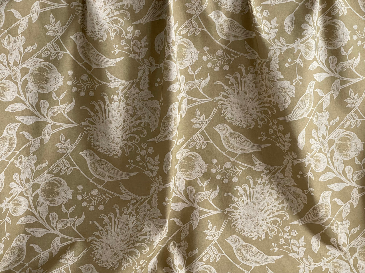 Textile with bird and floral pattern on beige background