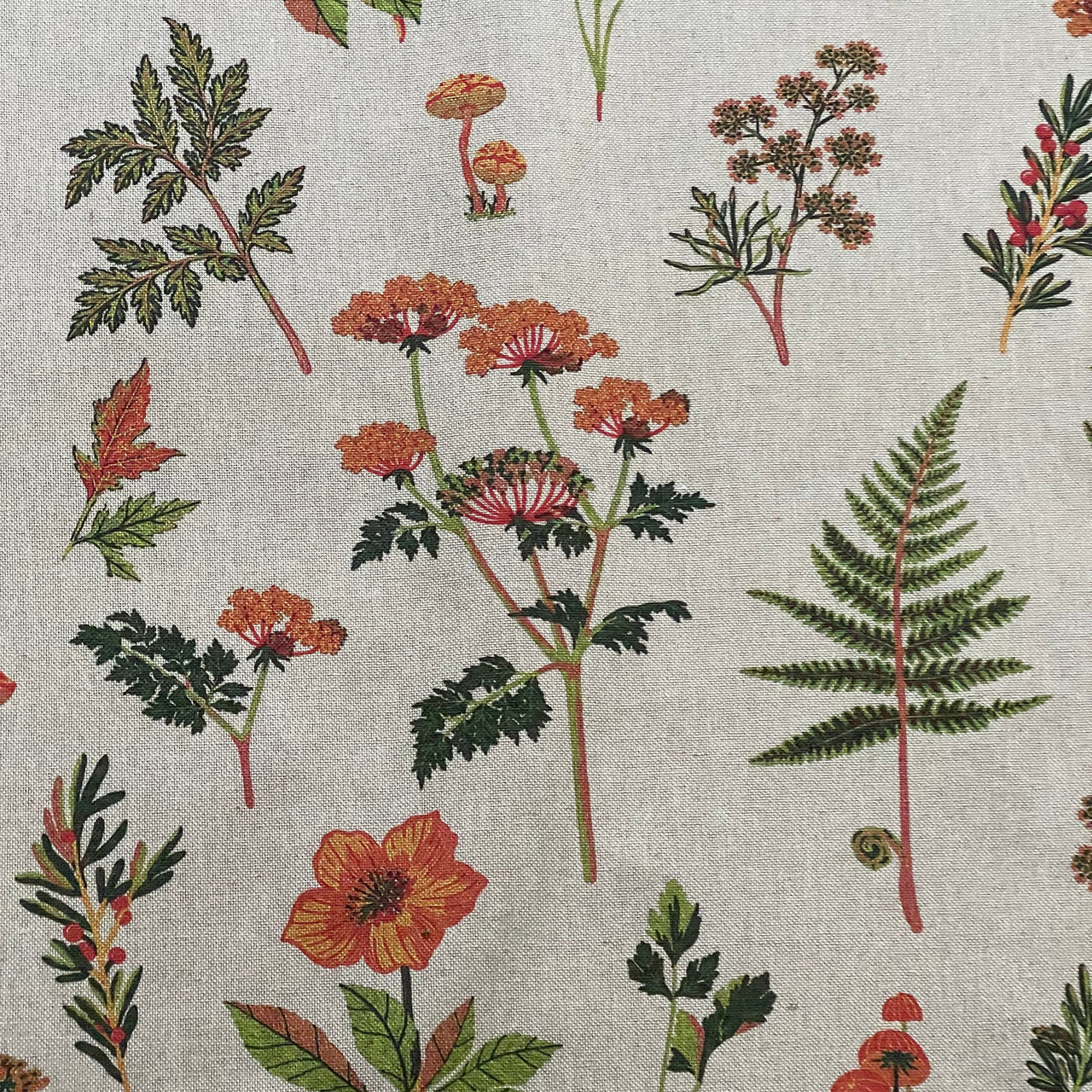 Country cottage style fabric featuring scattered mushrooms, wildflowers, green ferns and botanical stems.