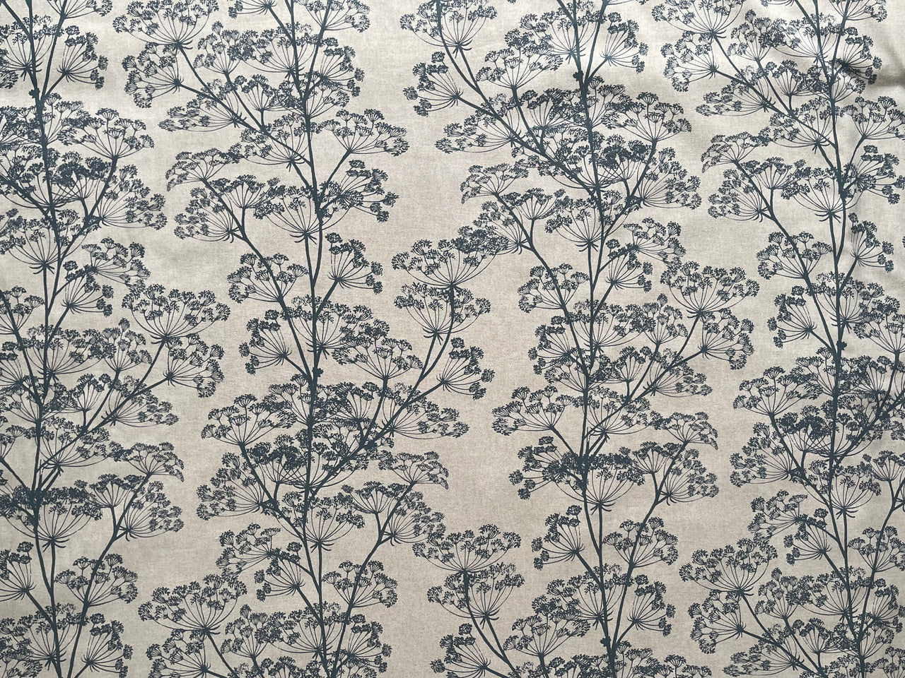 Close up of cow parsley floral fabric in indigo blue on oatmeal base