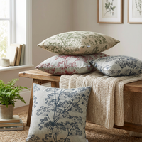 Thumbnail for Red, green and indigo cow parsley cushion covers styled on a rustic wooden bench