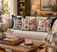 Thumbnail for Nautical sailing boat and rope knot cushions styled on a cream sofa with navy blue pillows and coastal accessories in a beach house living room.
 Copy