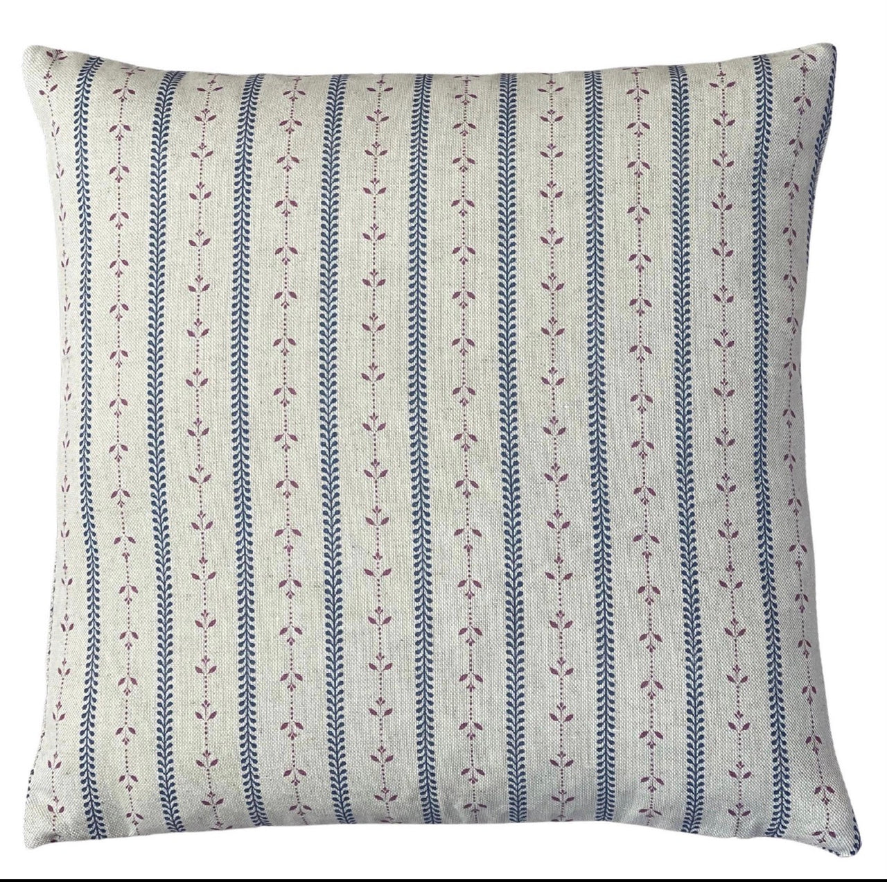 Dusty blue and mauve striped cushion covers styled with rust cushions on a country sofa
