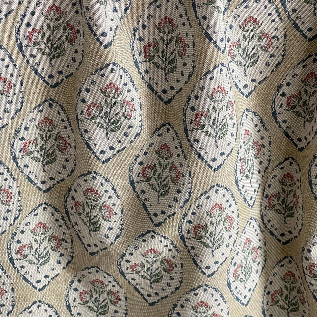 Soft drapery fabric with repeating floral medallion pattern on linen texture