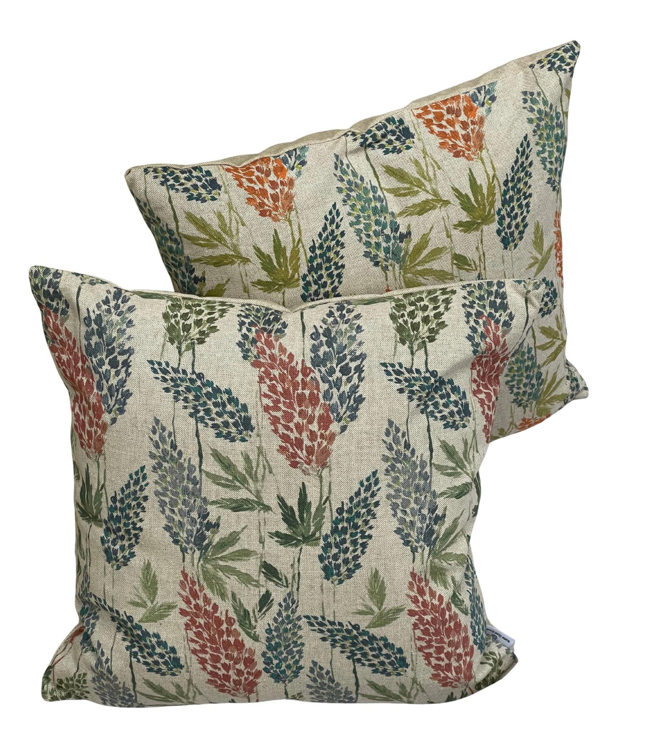 Pair of cushions—botanical clover and green stripe—on linen-look fabric.