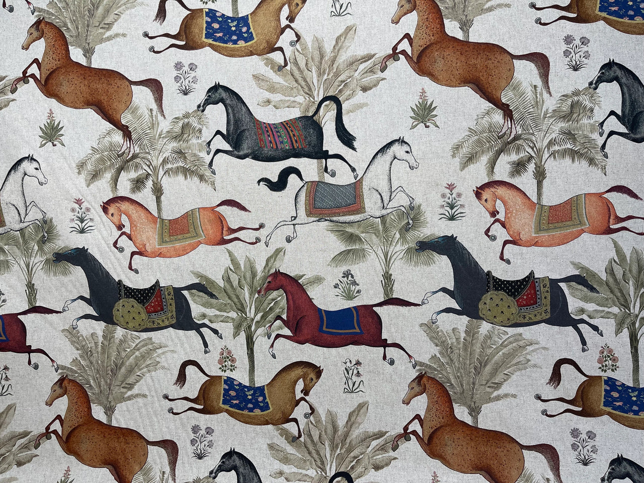 Pattern of horses and plants on a fabric background