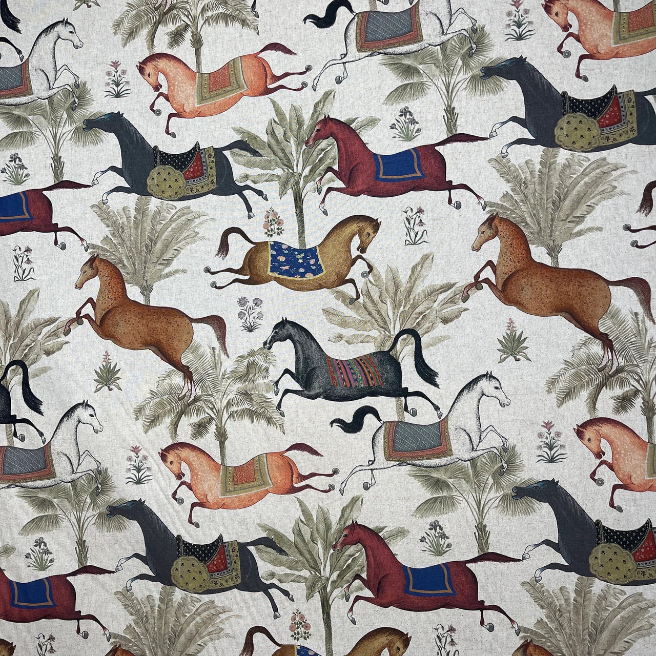 Patterned fabric with horses and trees on a beige background