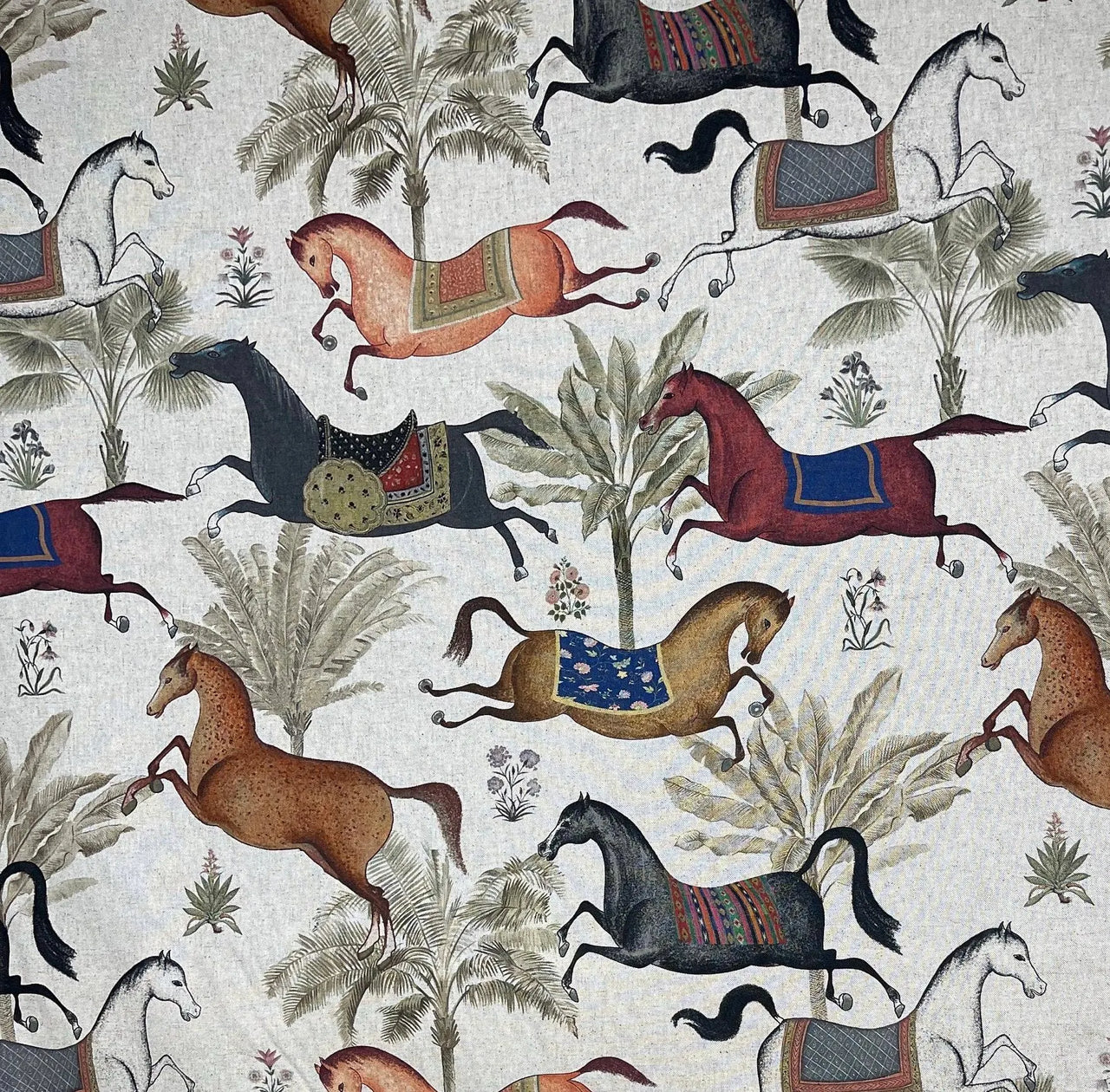 Pattern of horses and riders with saddle blankets on a light background