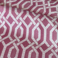 Thumbnail for Fabric with a geometric pattern of interlocking shapes in pink and white.