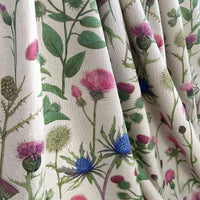 Thumbnail for Close-up of botanical thistle print cotton-linen fabric with pink, green, and blue florals on a natural beige background, ideal for curtains and soft furnishings.