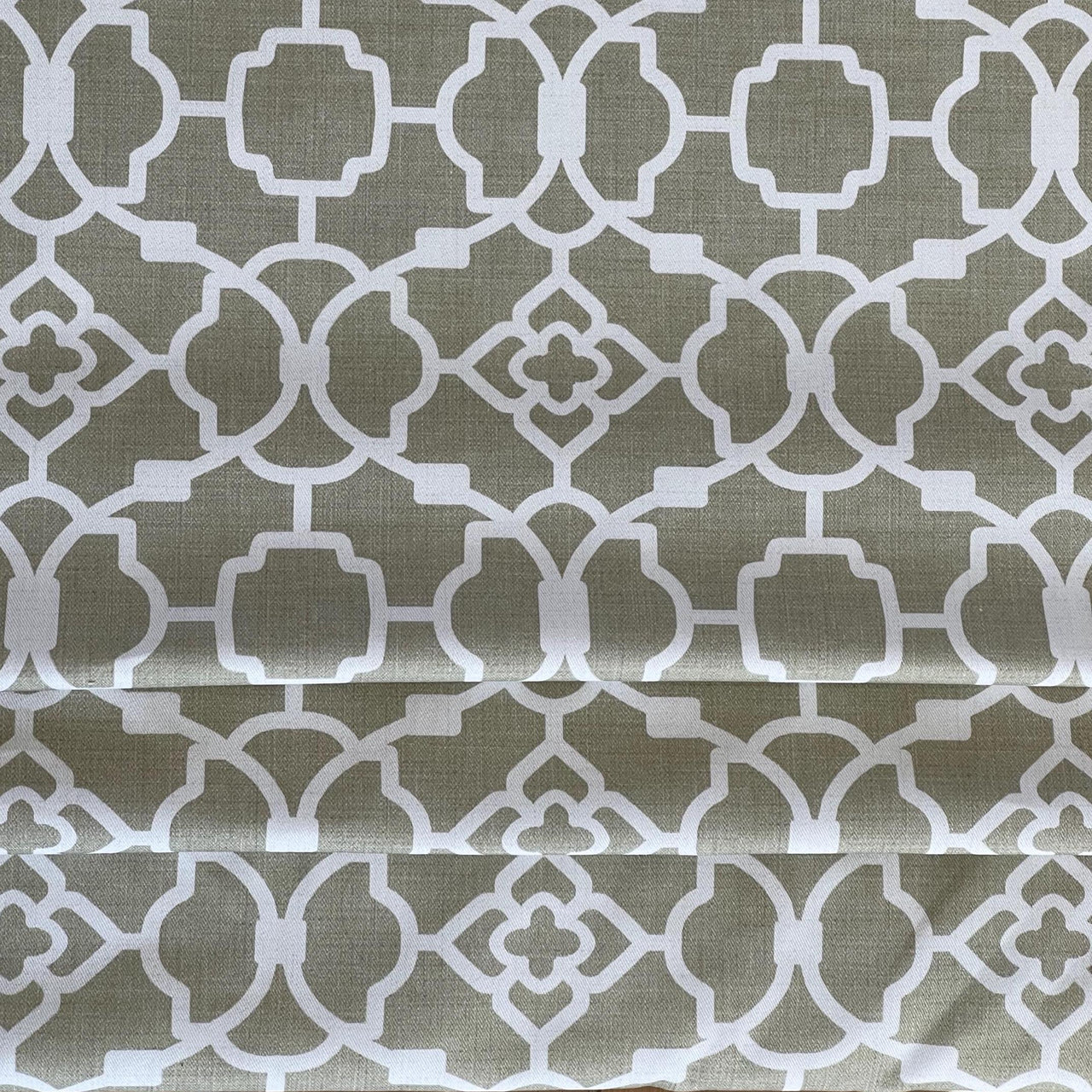 Folded cotton curtain fabric in soft khaki trellis design – ideal for made-to-measure Roman blinds and modern window treatments