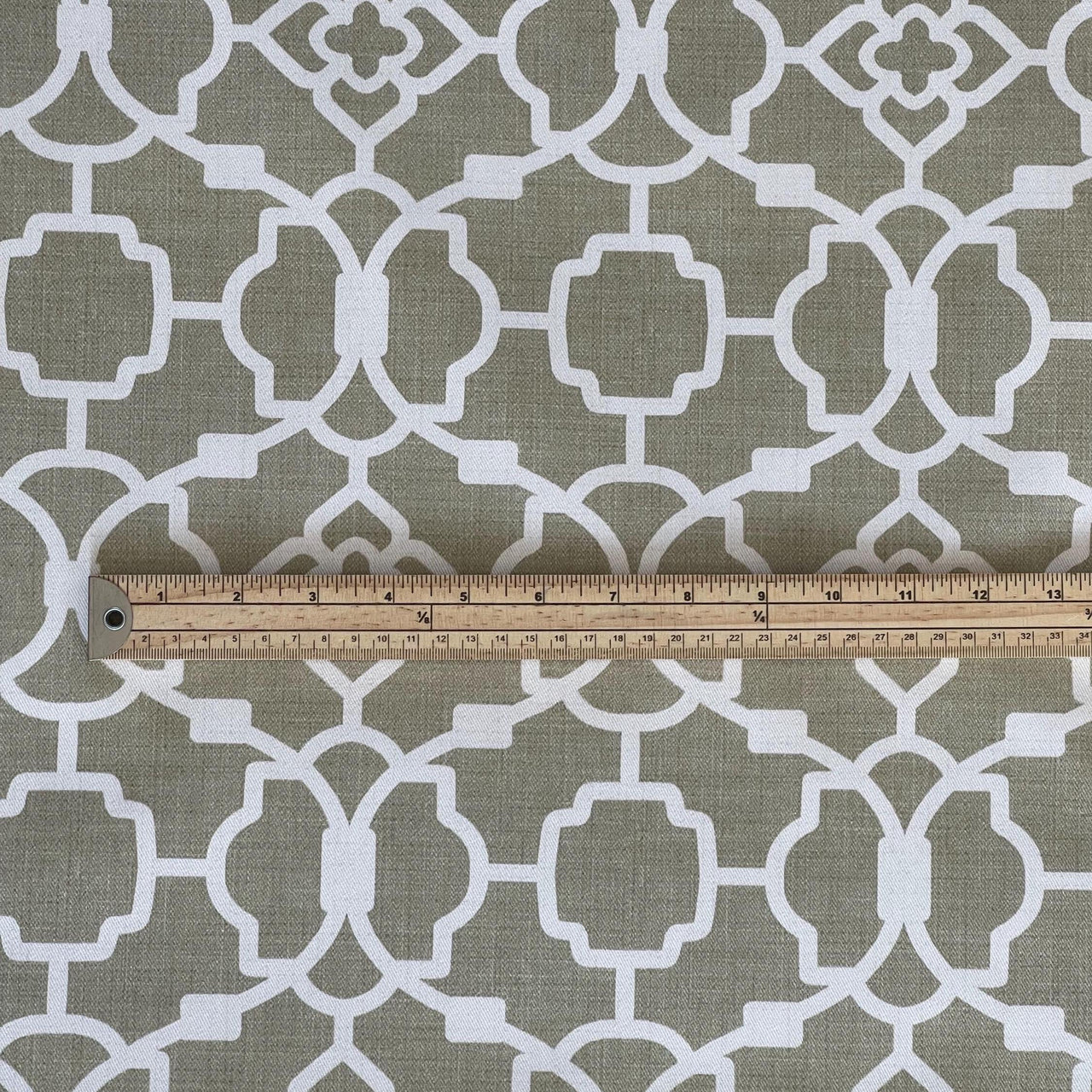 Taupe geometric cotton fabric with white trellis pattern and ruler for scale – ideal for custom window treatments and upholstery projects