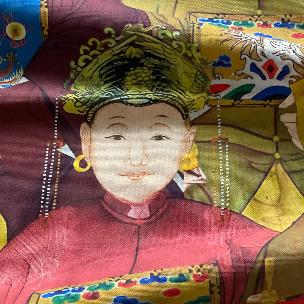 Multicoloured Imperial Court home decor fabric featuring repeating Chinese-inspired portraits and richly patterned ceremonial costumes.