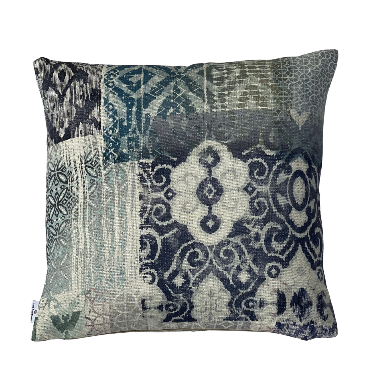 Indigo patchwork cushion cover in blue, teal, grey and natural tones with geometric woven-style motifs.