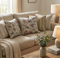 Thumbnail for Jacobean floral cushion covers in blush pink, sage green and natural tones styled with coordinating striped cushions on a neutral country living room sofa.
