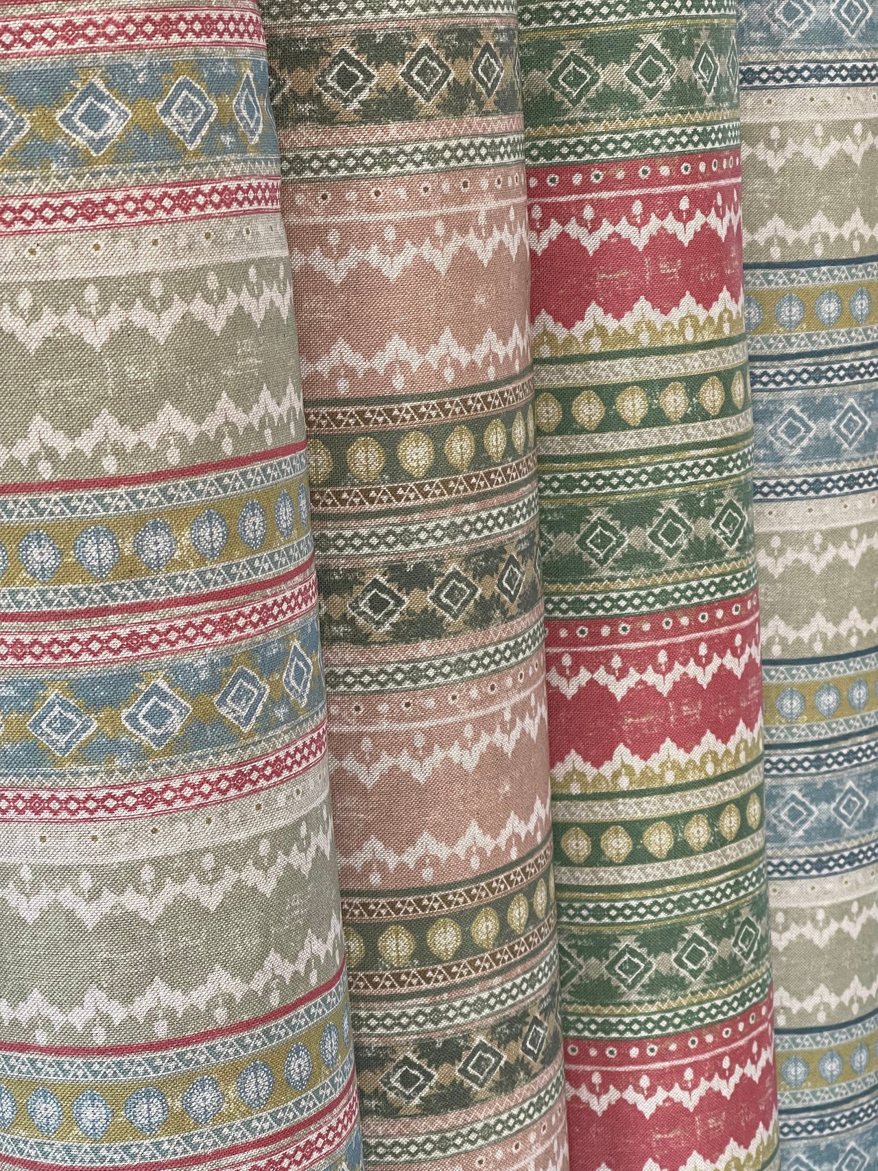 Patterned fabric with multicolor stripes and geometric designs.