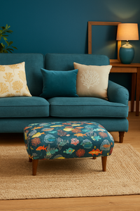 Thumbnail for Blue sofa with patterned cushions and matching ottoman in a living room setting.