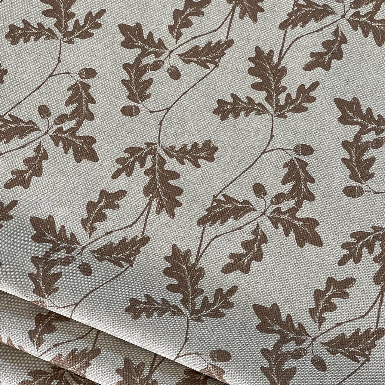 Beige cotton-linen fabric with brown oak leaf and acorn botanical print – ideal for natural home decor projects