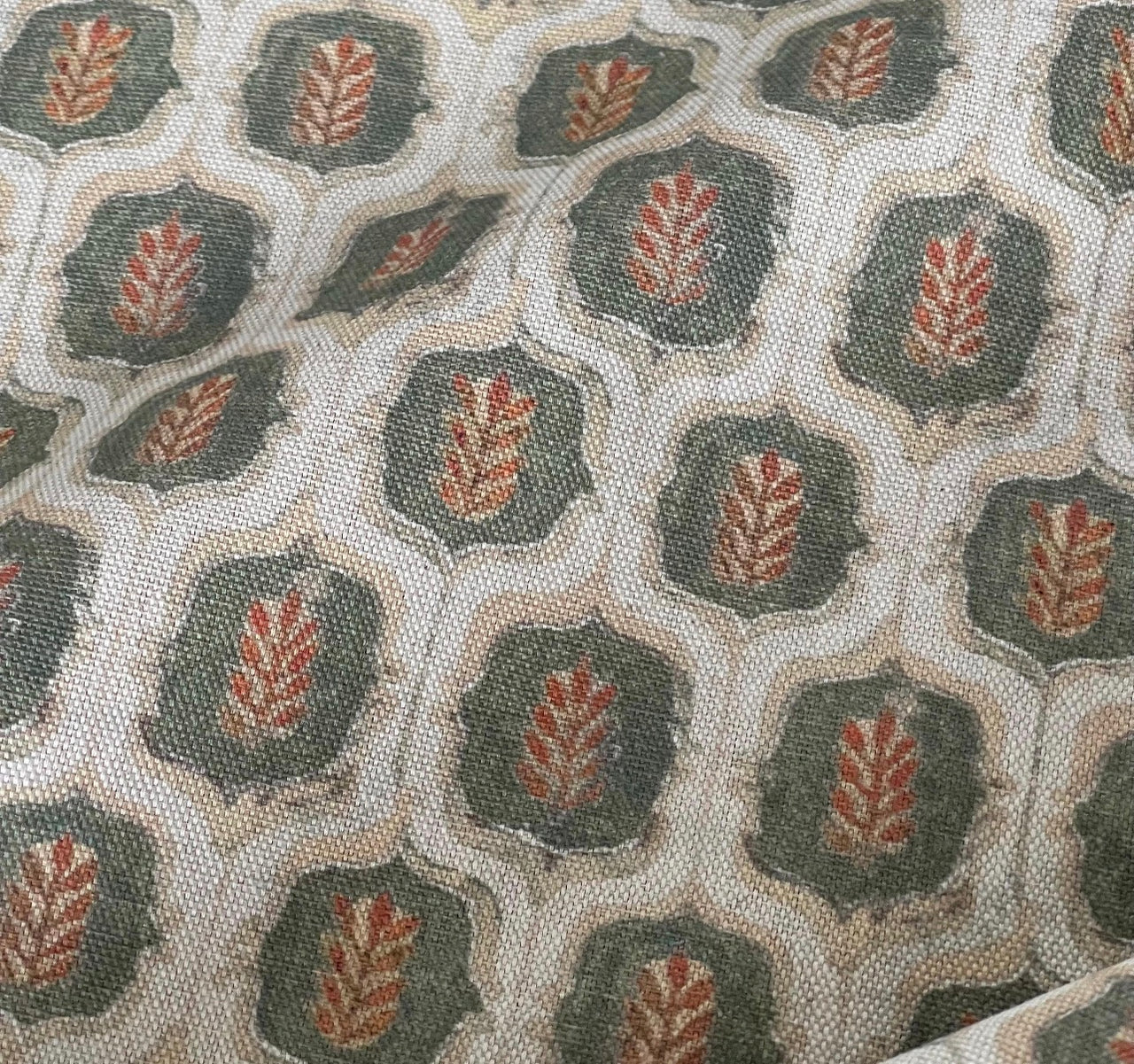 Close-up of olive green and rust leaf trellis linen-look cotton-blend fabric