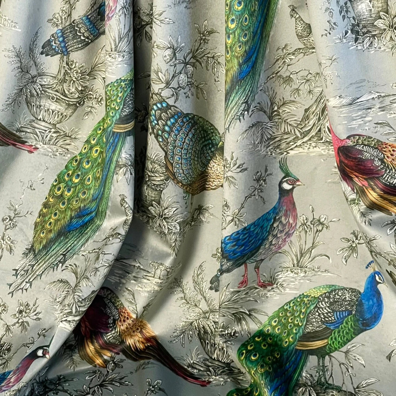 High-end Italian velvet fabric featuring colourful peacocks against elegant monochrome botanical background.