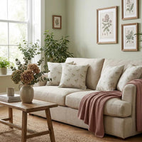Thumbnail for Pink Rose Meadow botanical cushion cover on a neutral sofa with soft blush throw and natural wooden furniture