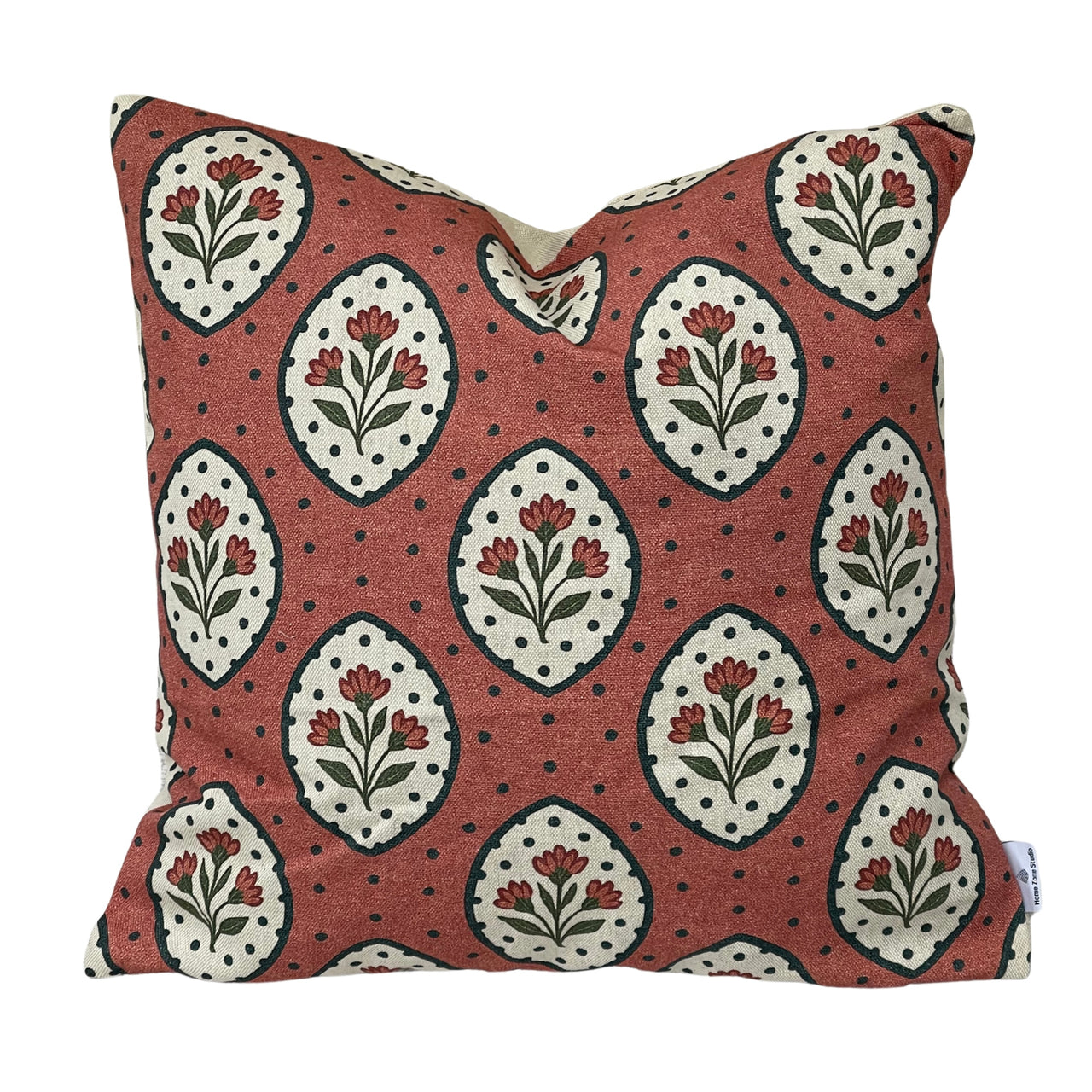 Handmade Rosewood Floral Medallion cushion cover featuring ivory teardrop motifs, red flowers and olive green leaves on terracotta pink cotton linen-look fabric.
