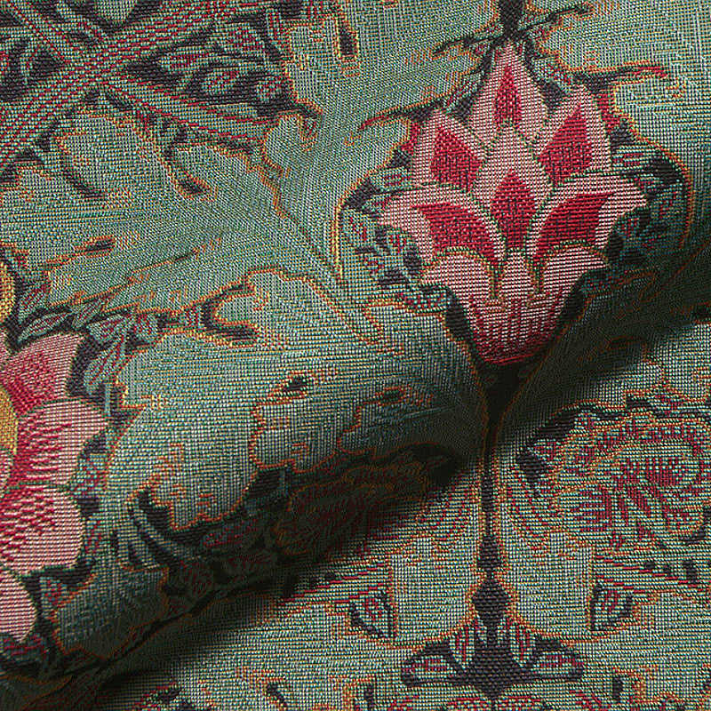 Close-up of Royal Botanical Upholstery Fabric showing intricate woven details with vintage pomegranate and floral motifs in green, red, and gold tones – heavy woven fabric ideal for upholstery and curtains.