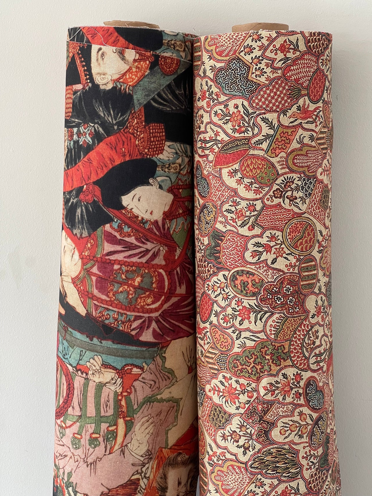 Side-by-side fabric rolls showing Oriental and Saffron Bloom floral prints