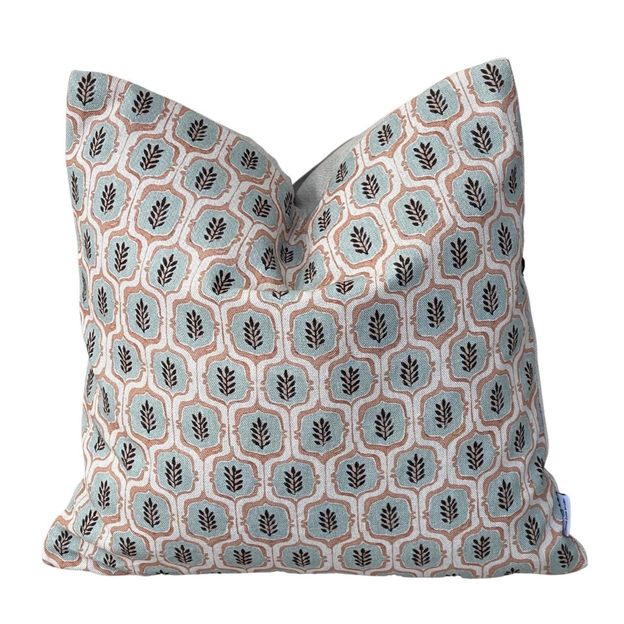 Sage green and rust leaf trellis cushion cover on a natural linen-look background