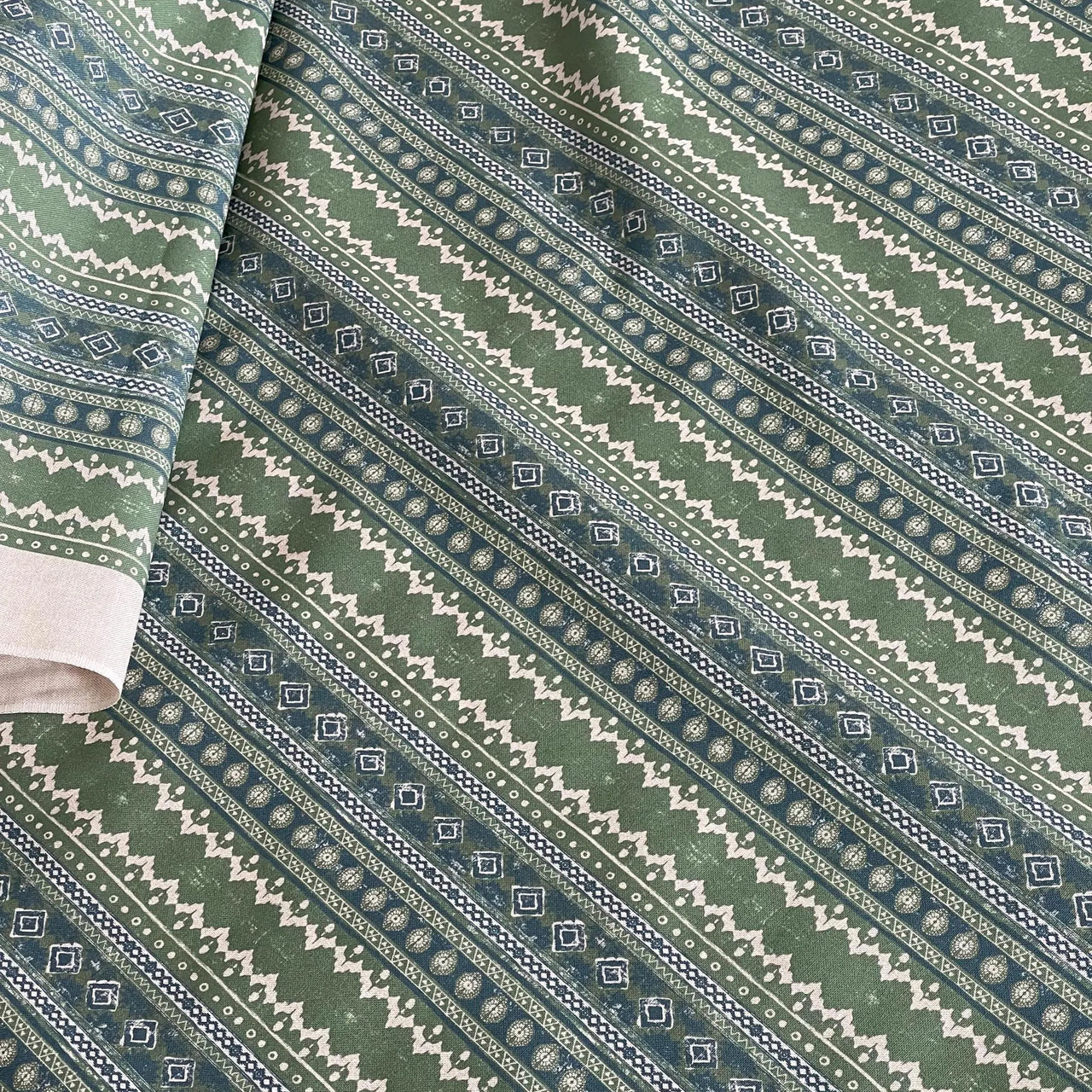 Green and cream ethnic stripe fabric with soft rustic texture – suitable for handcrafted window treatments, custom decor accents, and light upholstery.