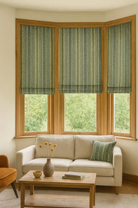 Thumbnail for Tailored Roman blinds and matching cushion in patterned sage cotton – artisan-style window dressing for warm neutral living spaces.