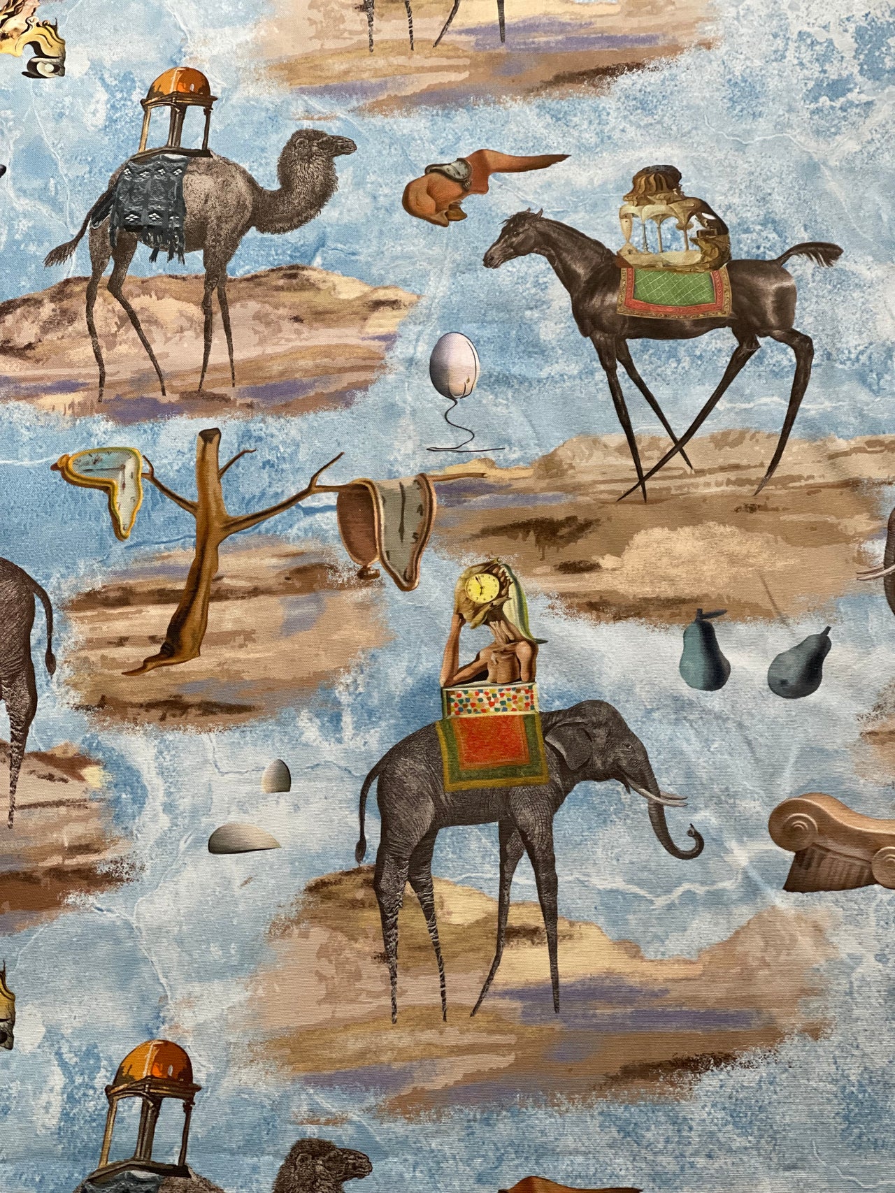 Salvador Dalí-inspired surrealist blue cotton furnishing fabric featuring elephants, camels, horses, melting clocks and dreamlike landscapes, ideal for curtains and Roman blinds.