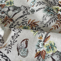 Thumbnail for Detailed shot of Savannah wildlife fabric with butterfly, green florals, and leopard on a soft beige linen-style weave — ideal for artisanal home projects.
