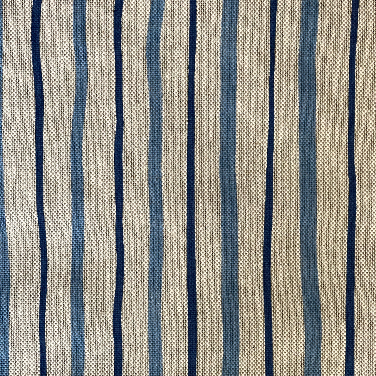 Close-up of the blue stripes and woven beige texture of Seabreeze fabric